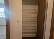 Thumbnail 13 of 16 - A room with a window and a door leading to a hallway.