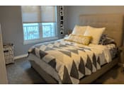 Thumbnail 8 of 24 - a bedroom with a bed and a window