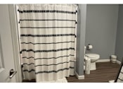 Thumbnail 9 of 24 - a bathroom with a toilet and a shower curtain