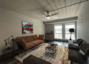 Thumbnail 11 of 29 - an empty living room with a ceiling fan