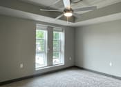 Thumbnail 15 of 29 - an empty room with a ceiling fan and a window