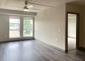 Thumbnail 12 of 29 - an empty living room with a ceiling fan