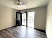Thumbnail 18 of 29 - an empty living room with a ceiling fan