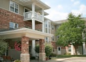 Thumbnail 3 of 37 - an apartment building with a porch and a dog on the balcony