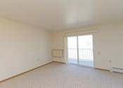 Thumbnail 6 of 37 - an empty living room with a sliding glass door to a balcony
