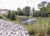 Thumbnail 35 of 37 - a fountain in the middle of a pond in a garden