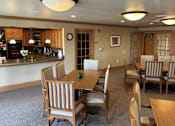 Thumbnail 23 of 37 - A dining room with a table set for six.