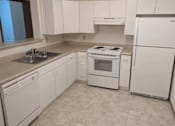Thumbnail 7 of 37 - a white kitchen with white appliances and white cabinets