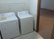 Thumbnail 16 of 37 - three washing machines in a room next to a door
