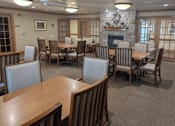 Thumbnail 24 of 37 - a dining room with tables and chairs and a fireplace