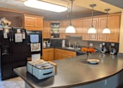 Thumbnail 26 of 37 - a kitchen with a counter top and a refrigerator