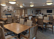 Thumbnail 25 of 37 - a dining room with tables and chairs and a fireplace