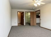 Thumbnail 11 of 37 - an empty living room with a ceiling fan and a closet