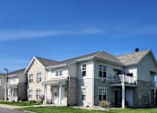 Thumbnail 1 of 21 - A row of houses with a clear blue sky above them.