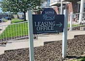 Thumbnail 19 of 21 - A sign for the leasing office of Saddle Brook Apartments.