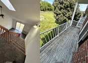 Thumbnail 15 of 21 - A house with a deck and stairs.