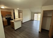 Thumbnail 7 of 21 - A kitchen with a white counter and wooden cabinets.