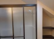 Thumbnail 16 of 29 - A glass door with a black frame is in the foreground.