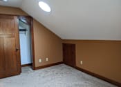 Thumbnail 17 of 29 - A room with a carpeted floor and two doors.