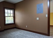 Thumbnail 18 of 29 - A room with brown walls and a window with blinds.