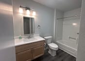 Thumbnail 8 of 19 - A bathroom with a toilet, sink, and shower.