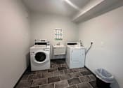Thumbnail 9 of 19 - A laundry room with a washer and dryer.