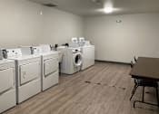 Thumbnail 10 of 15 - A laundry room with washers and dryers.