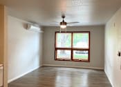 Thumbnail 4 of 15 - A room with a window and a ceiling fan.