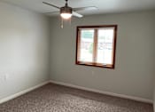 Thumbnail 8 of 15 - A room with a ceiling fan and a window with blinds.