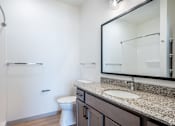 Thumbnail 11 of 54 - A white toilet sits in a bathroom next to a sink.