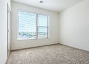 Thumbnail 54 of 54 - A room with a carpeted floor and a window with blinds.