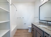 Thumbnail 12 of 54 - A bathroom with a toilet, sink, and mirror.