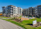 Thumbnail 1 of 80 - Apartment complex named The Flats with a playground in front.