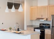Thumbnail 3 of 39 - a kitchen with a granite counter top and a sink