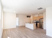 Thumbnail 4 of 39 - an empty living room and kitchen with white walls and wood floors