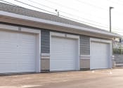 Thumbnail 23 of 39 - three garage doors on the side of a building