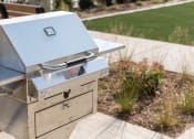 Thumbnail 21 of 39 - a silver smoker grill sitting on a table in a garden