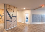 Thumbnail 16 of 39 - a lockers room in a renovated basement with wood flooring and a wall with