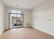 Thumbnail 13 of 80 - A room with a sliding glass door leading to a balcony.