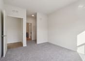 Thumbnail 19 of 80 - A room with white walls and a grey carpet.