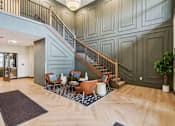 Thumbnail 23 of 80 - A spacious living room with a staircase and a dining area.