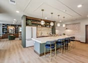 Thumbnail 32 of 80 - A kitchen with a bar area and a white fridge.