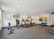 Thumbnail 28 of 80 - A spacious home gym with a variety of exercise equipment.