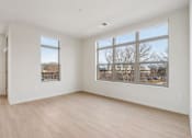 Thumbnail 11 of 80 - A room with a large window and a sliding glass door.