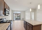 Thumbnail 8 of 80 - A kitchen with granite countertops and wooden cabinets.
