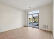 Thumbnail 14 of 80 - A room with a sliding glass door leading to a patio.