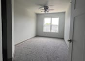 Thumbnail 5 of 13 - an empty room with a ceiling fan and a window