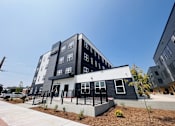 Thumbnail 2 of 13 - a building with a black and white facade