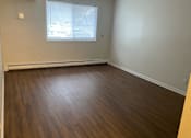 Thumbnail 13 of 36 - A room with wooden flooring and a window.