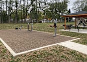 Thumbnail 29 of 36 - A playground with a swing set and a seesaw.